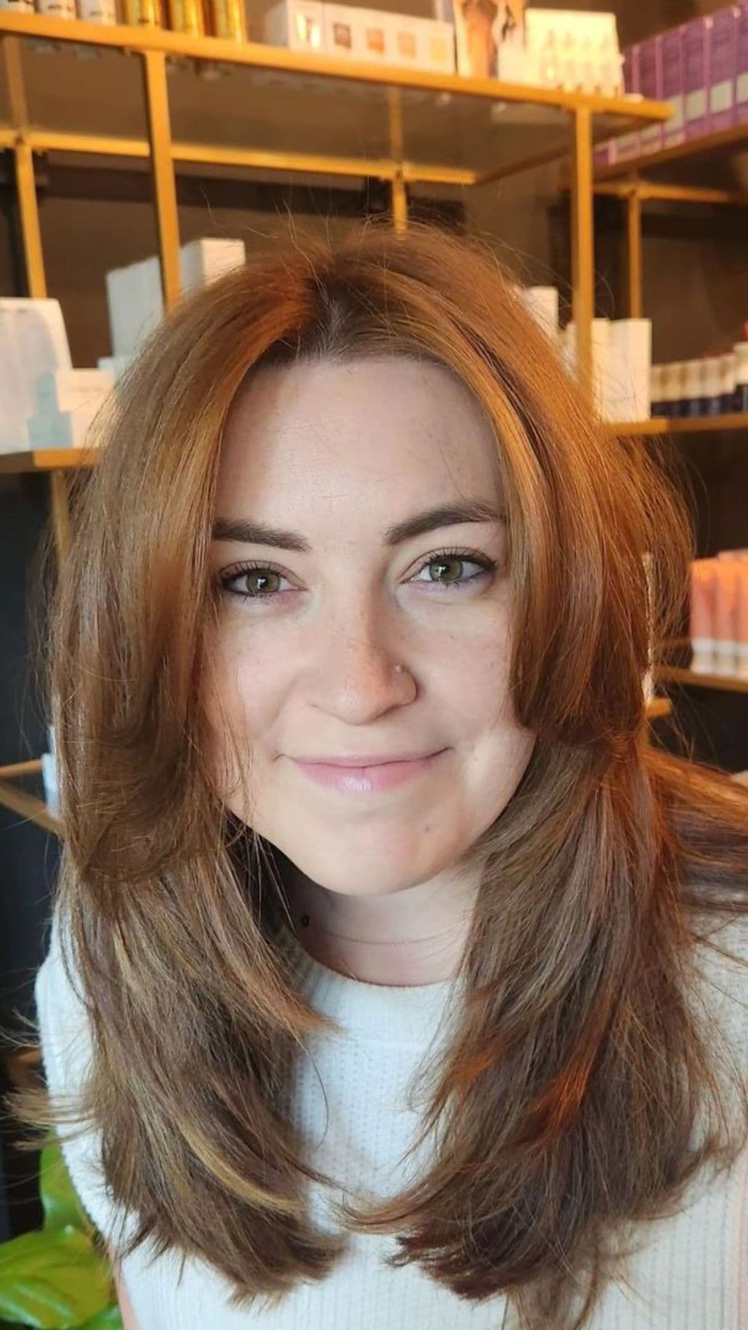 A woman modelling a face-framing style for medium hair.