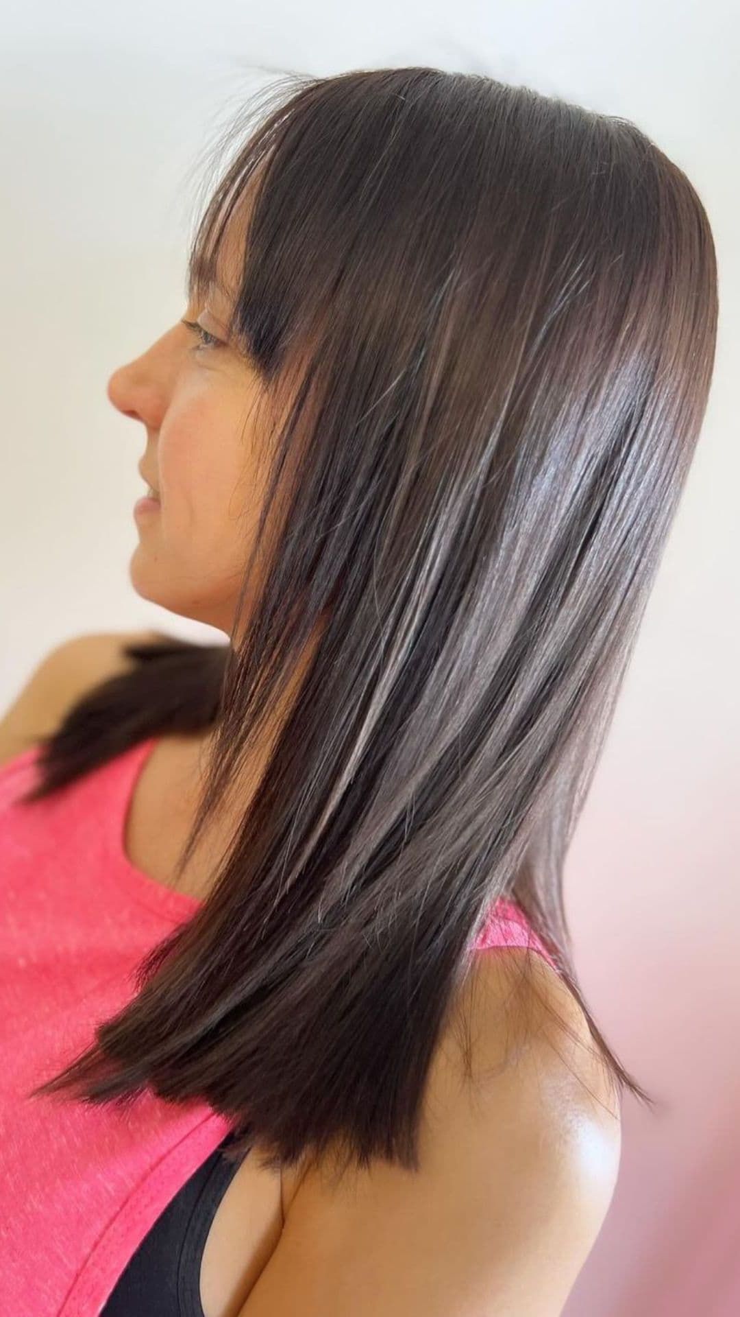 A woman modelling a blunt cut medium haircut.