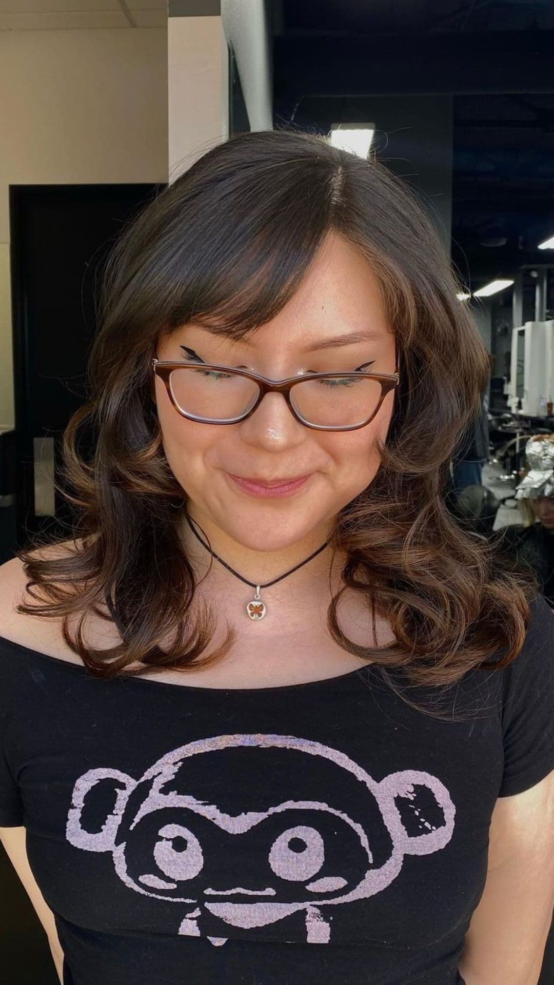 A woman modelling a strong side part hairstyle.
