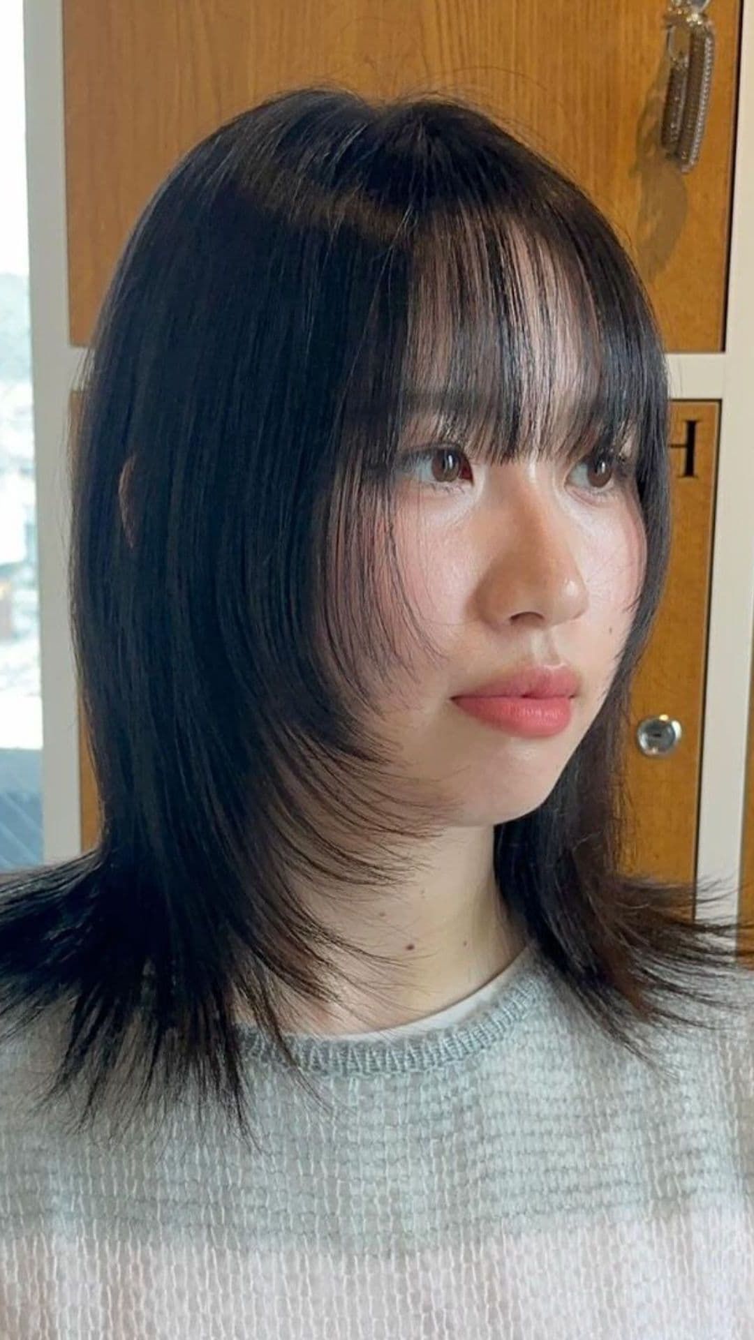A woman modelling a Hush haircut.