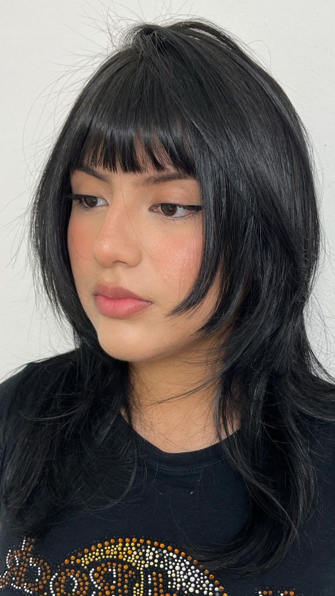 A woman modelling a wispy layers hairstyle.