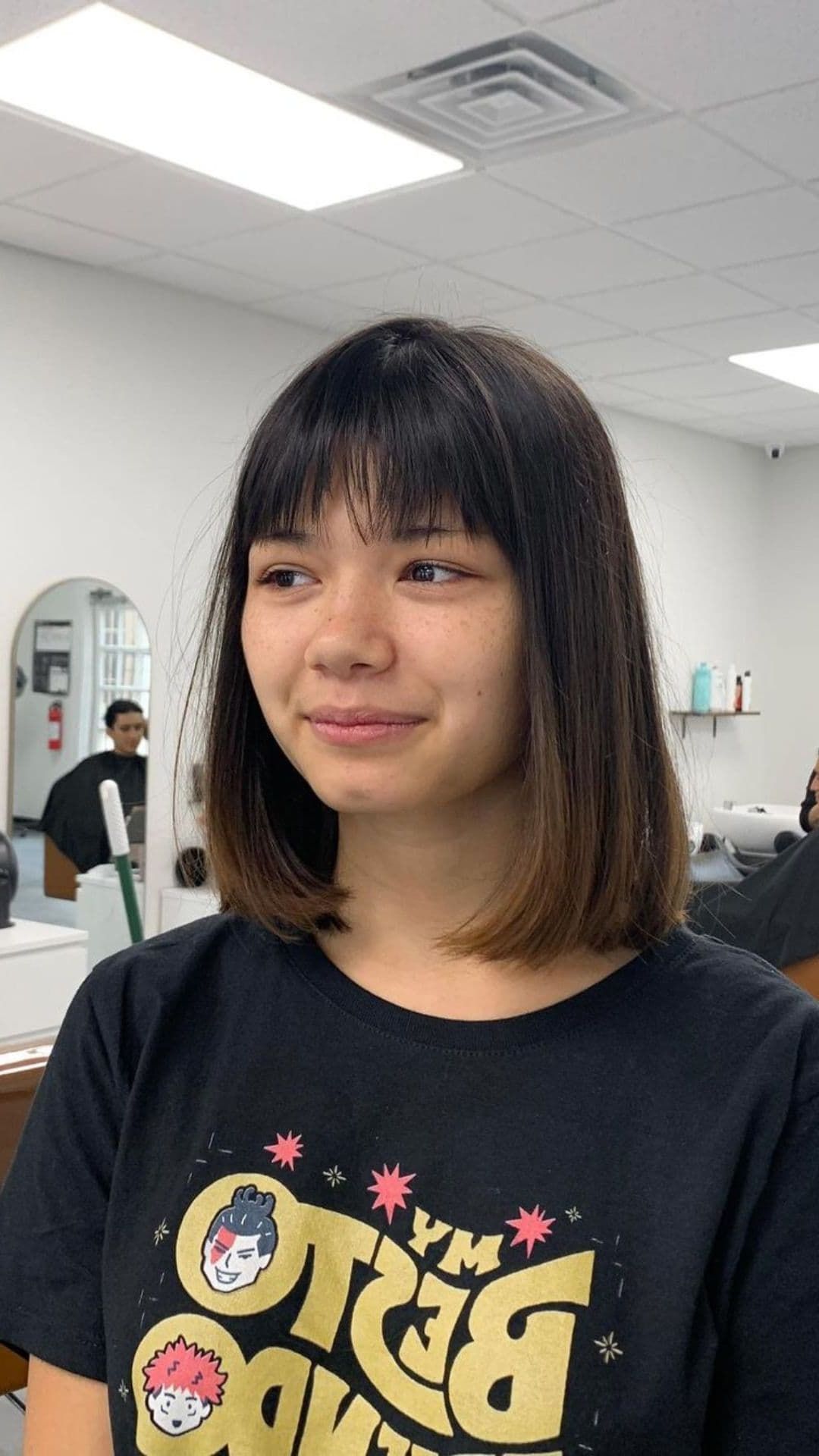 A woman modelling a bob cut with wispy bangs.